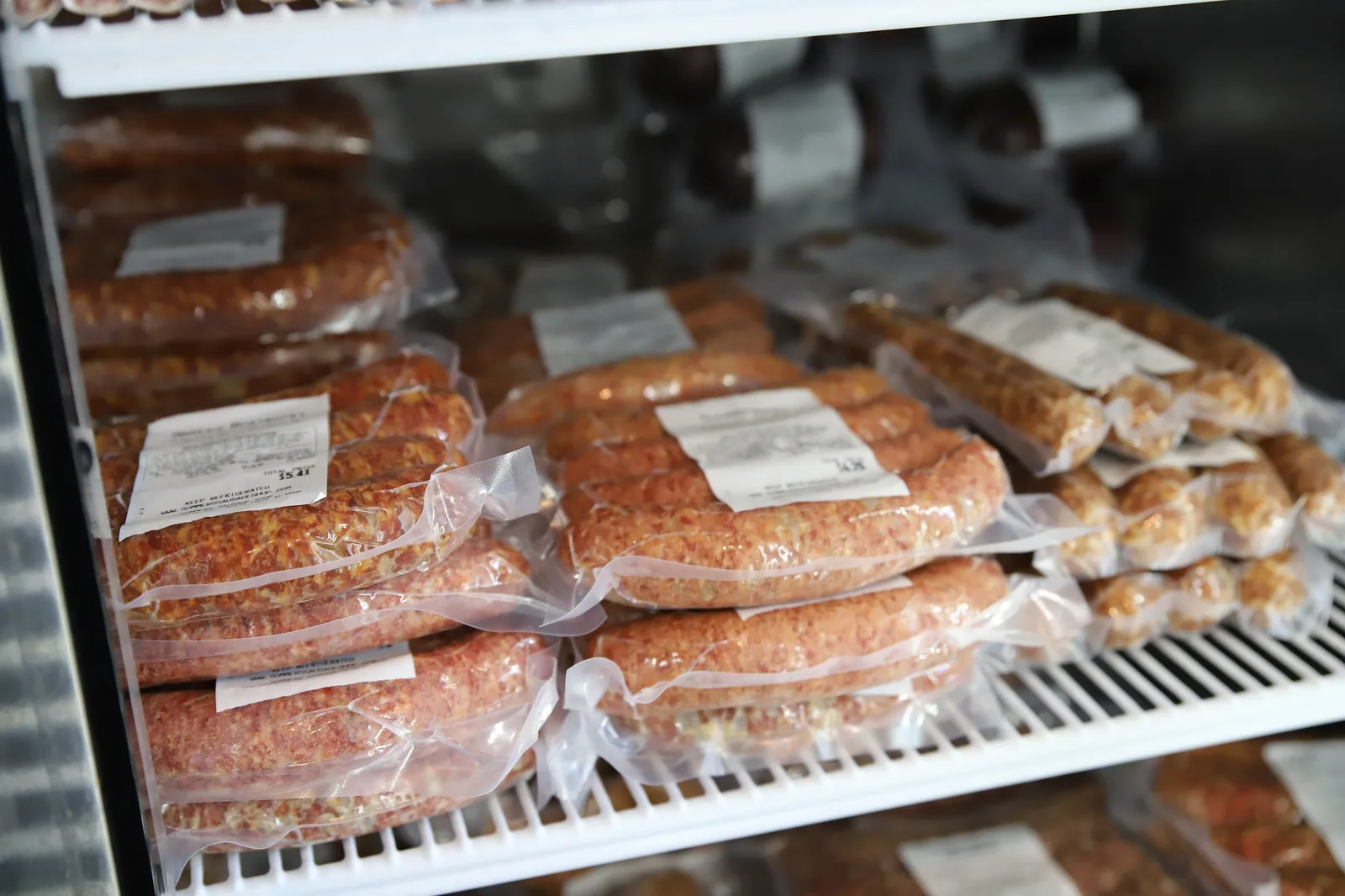 Display case stocked with fresh sausages and brats