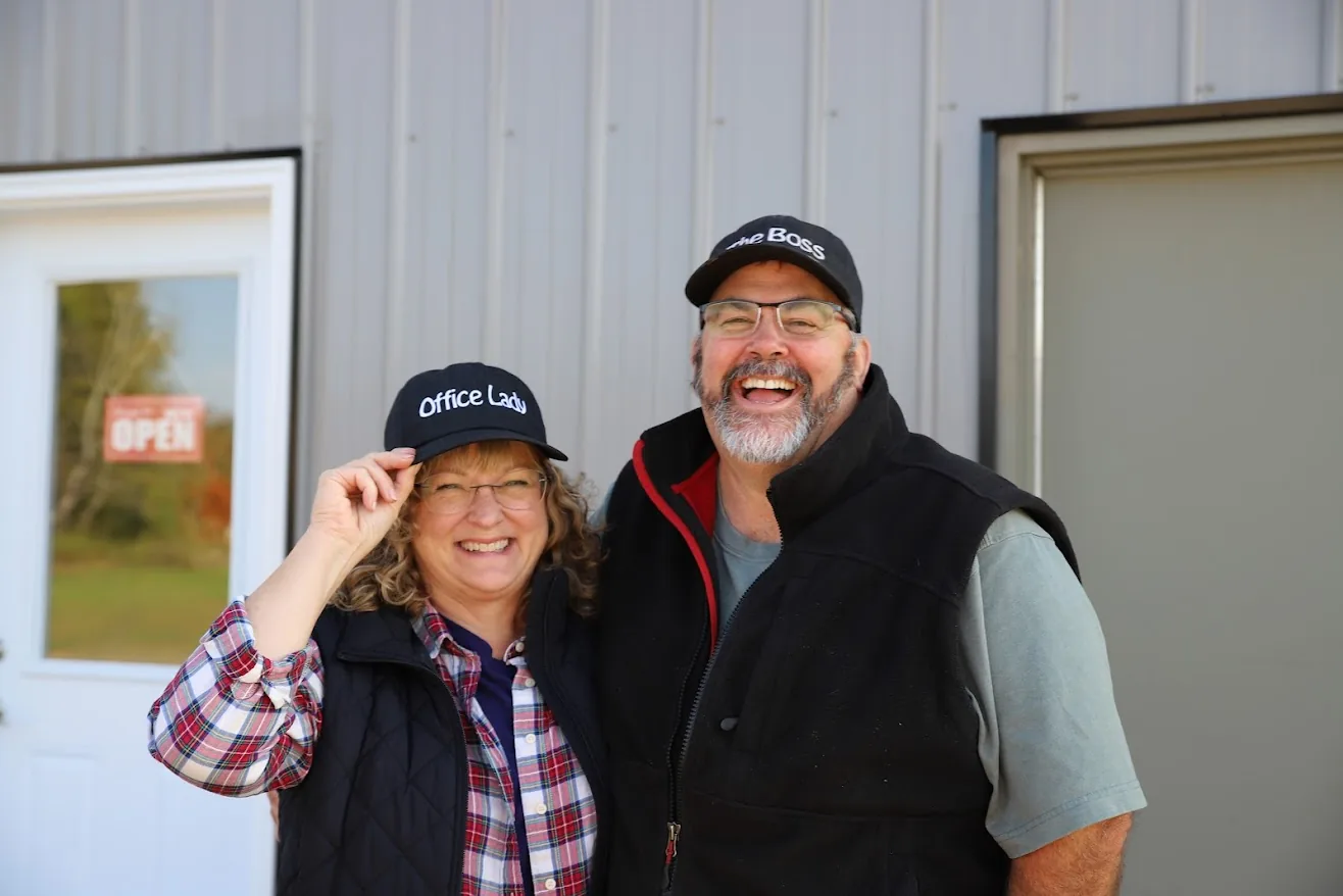 Pat and Chris sharing a laugh outside the shop