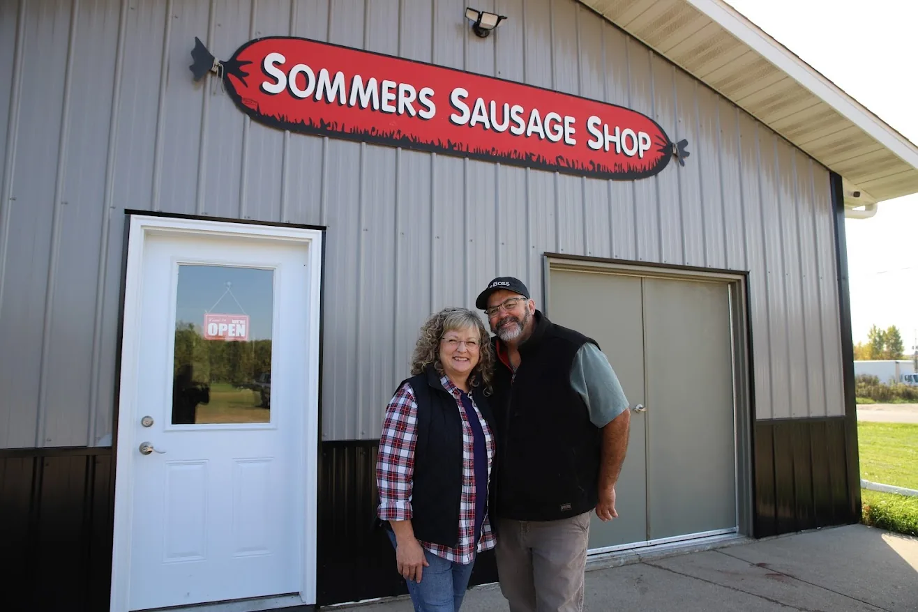 Pat and Chris standing in front of Sommers Sausage Shop